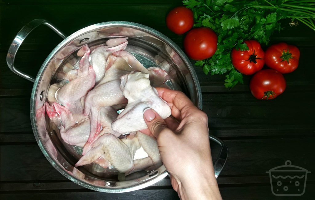 chicken wings in a boiling utensil
