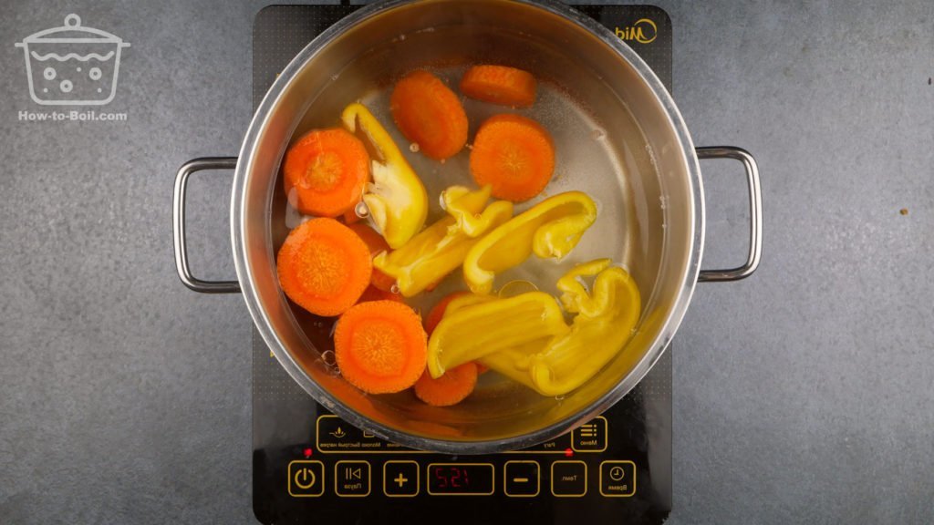 salt, carrots, and bell peppers in heating water